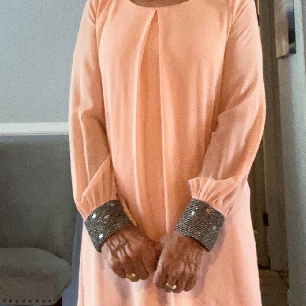 Stylish peach colored beaded dress.